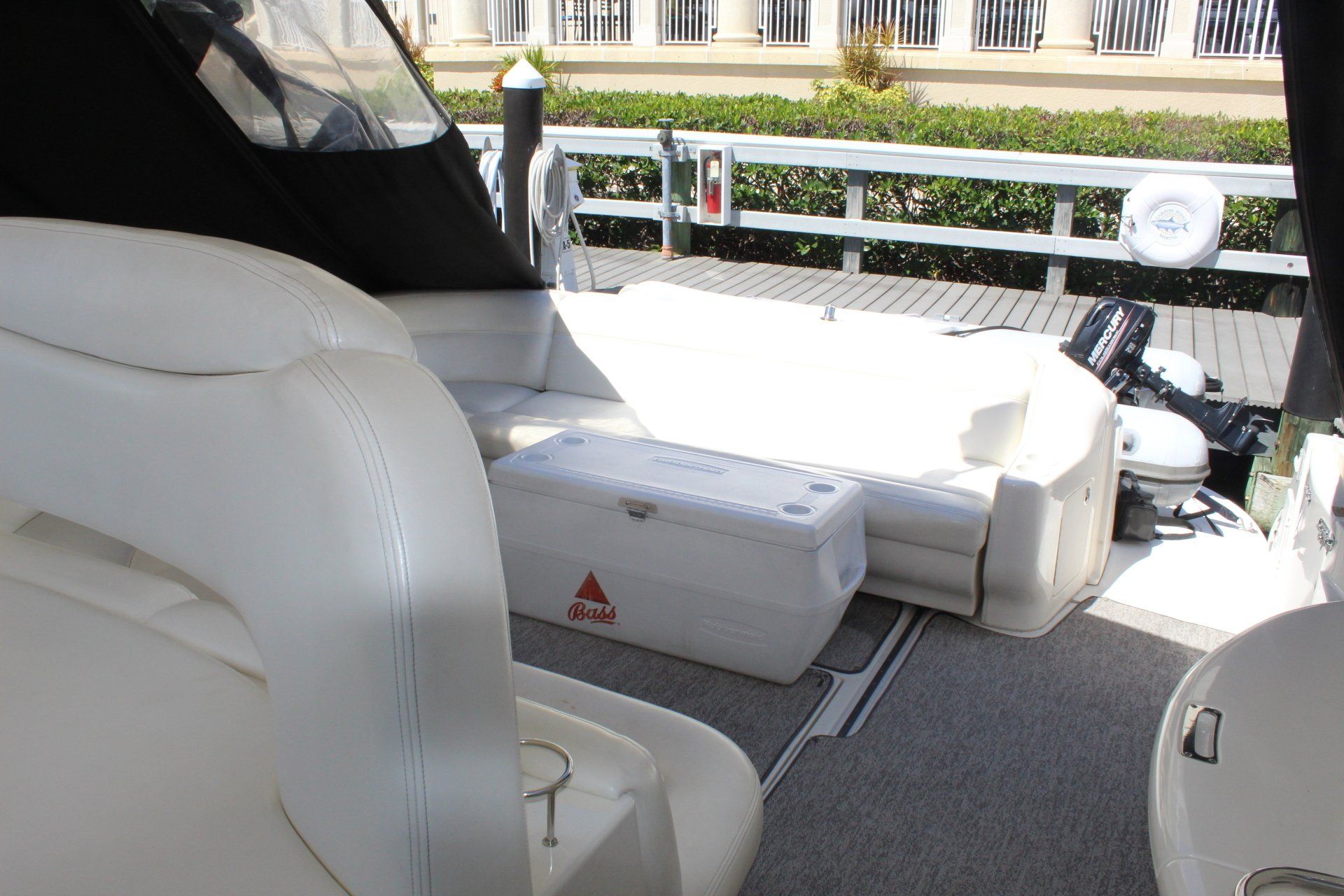 A boat with a mercury motor is docked at a dock