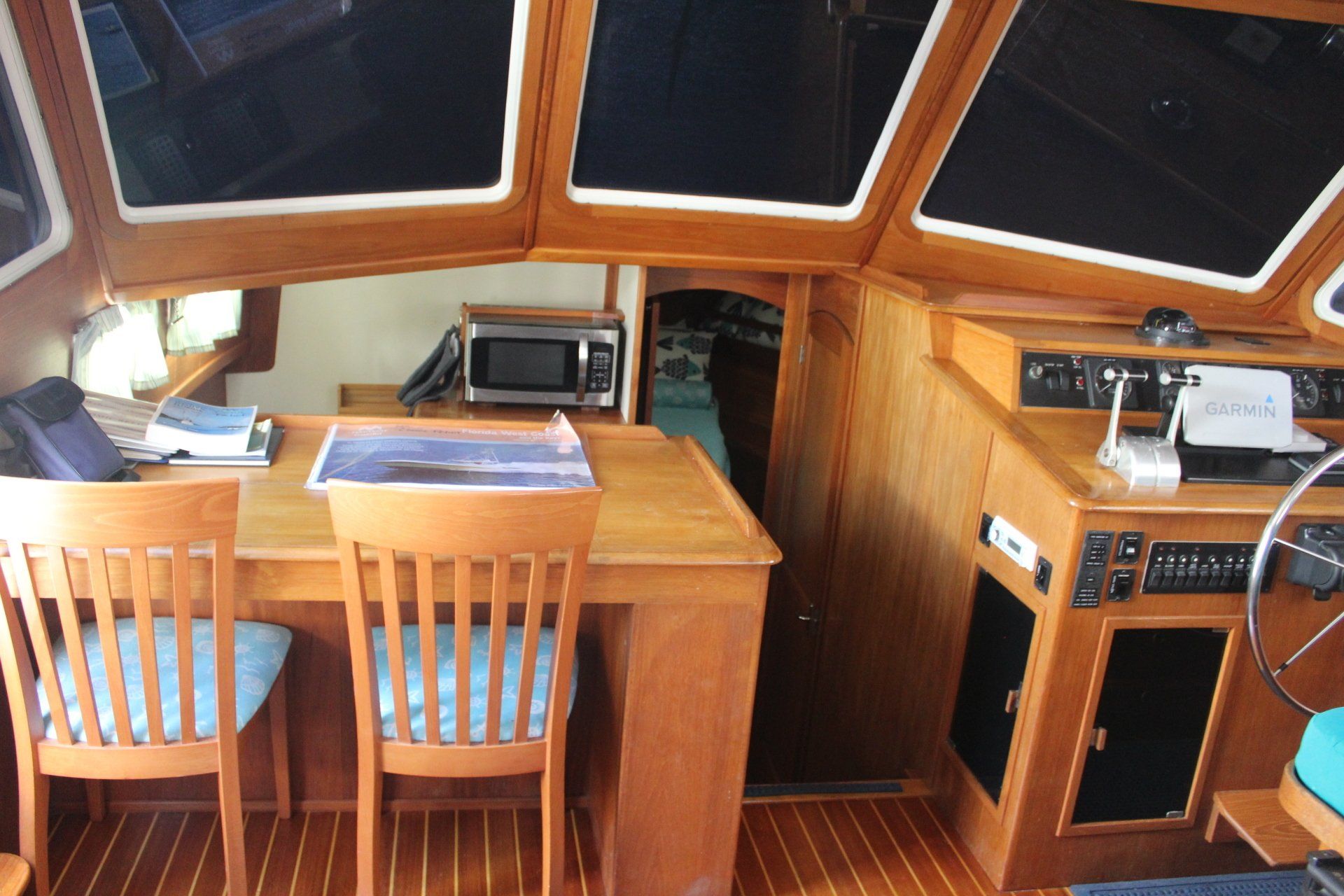 The inside of a boat with a table and chairs