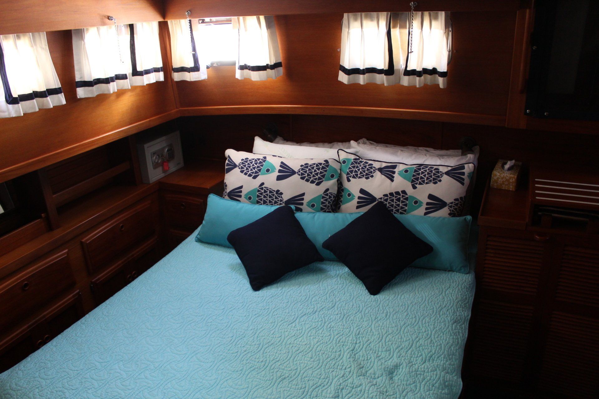 A bedroom on a boat with a bed and pillows