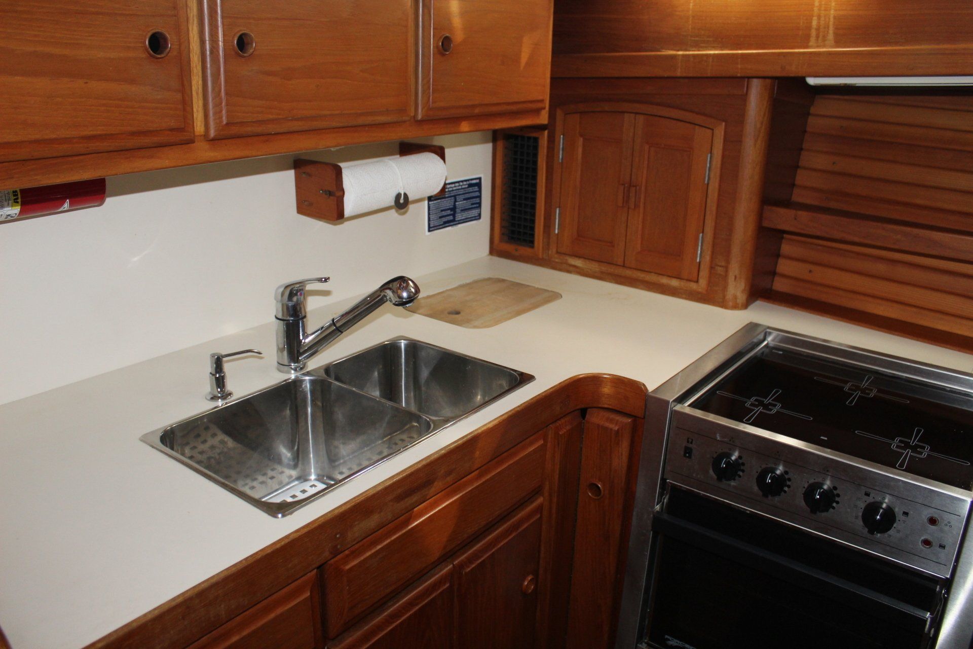 A kitchen with two sinks and a stove top oven