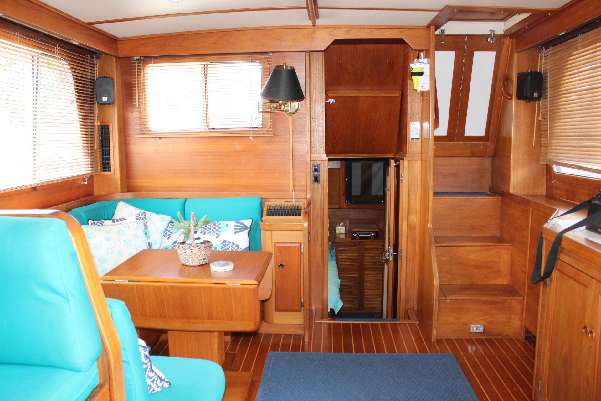 A living room on a boat with a couch and table