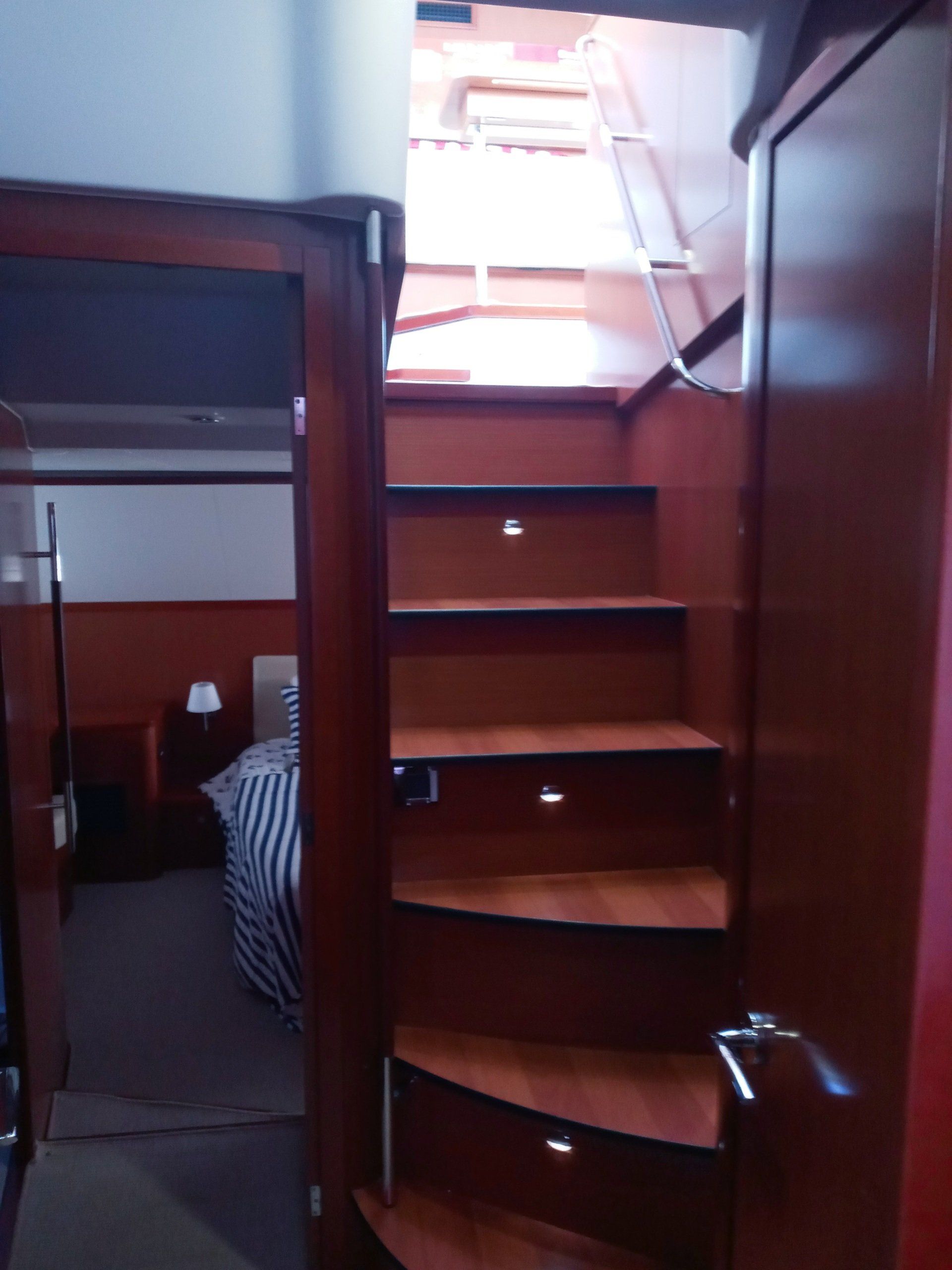 A set of wooden stairs leading up to a bedroom