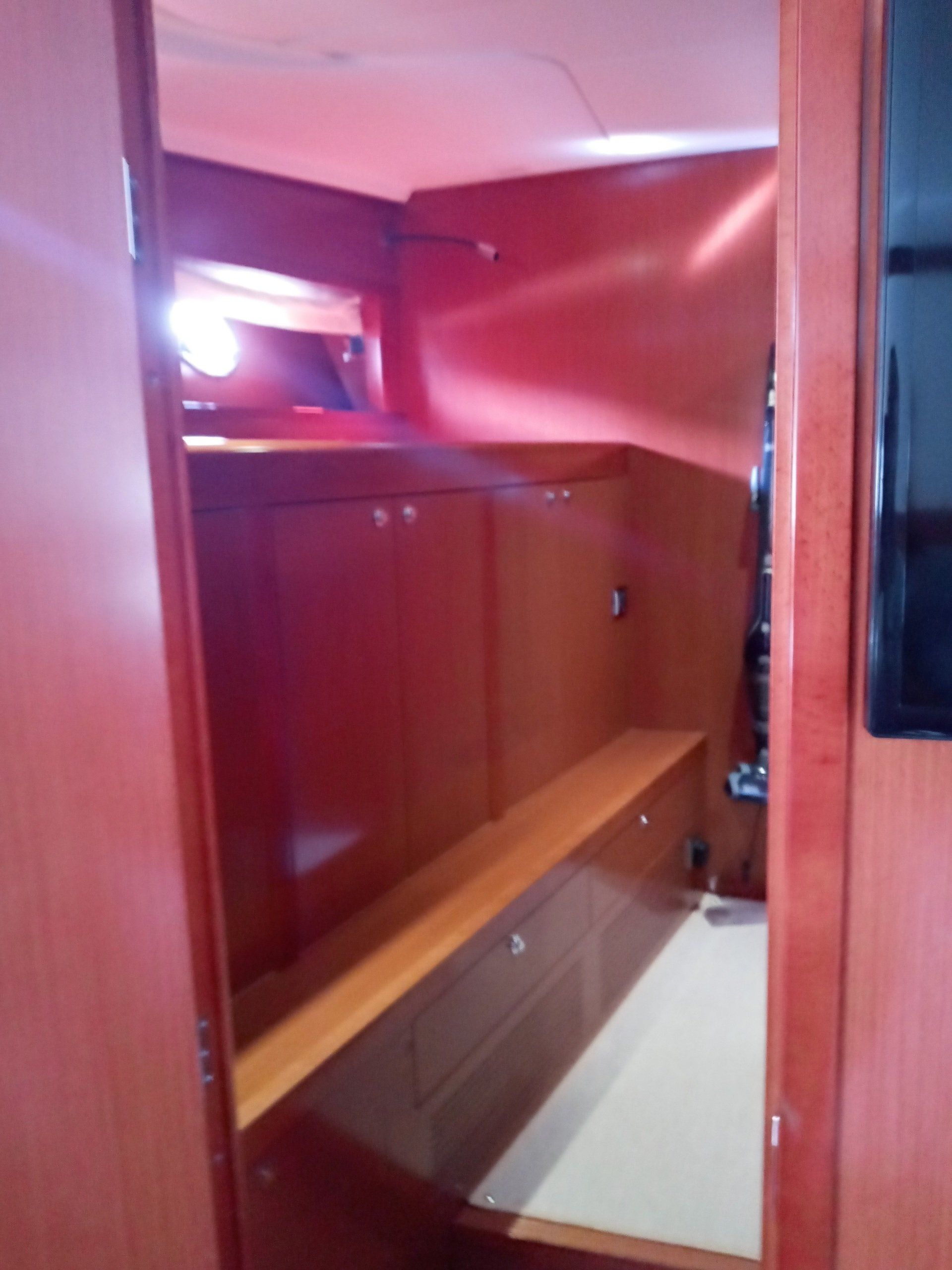 A room with a red ceiling and wooden shelves