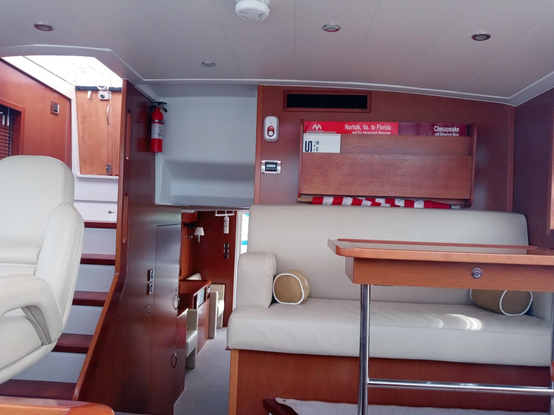 The inside of a boat with a couch and table