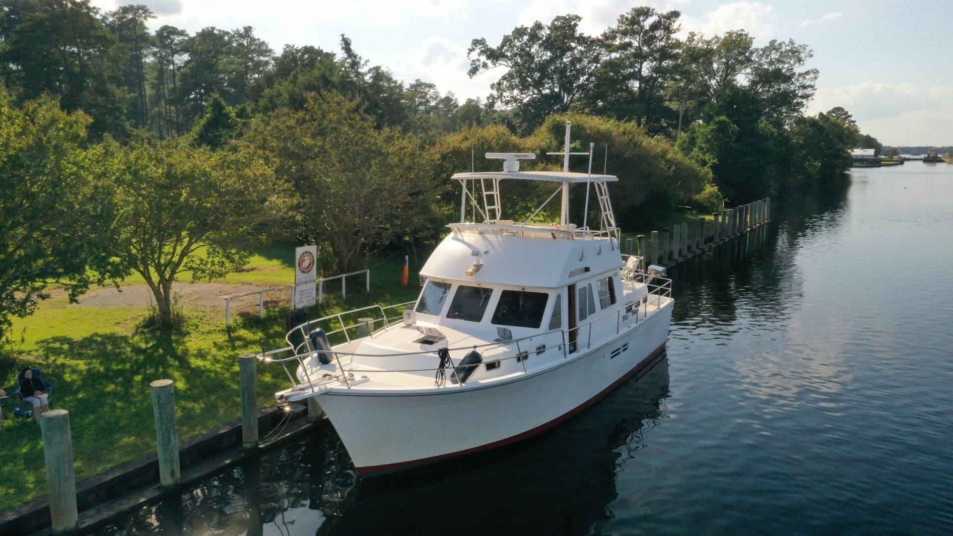 An aerial view of a white boat floating on top of a body of water.