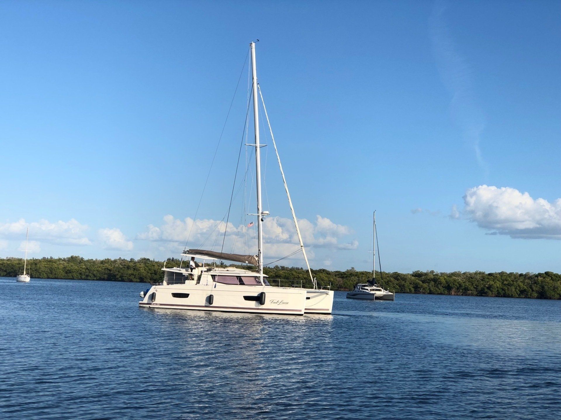 A sailboat is floating on top of a large body of water.