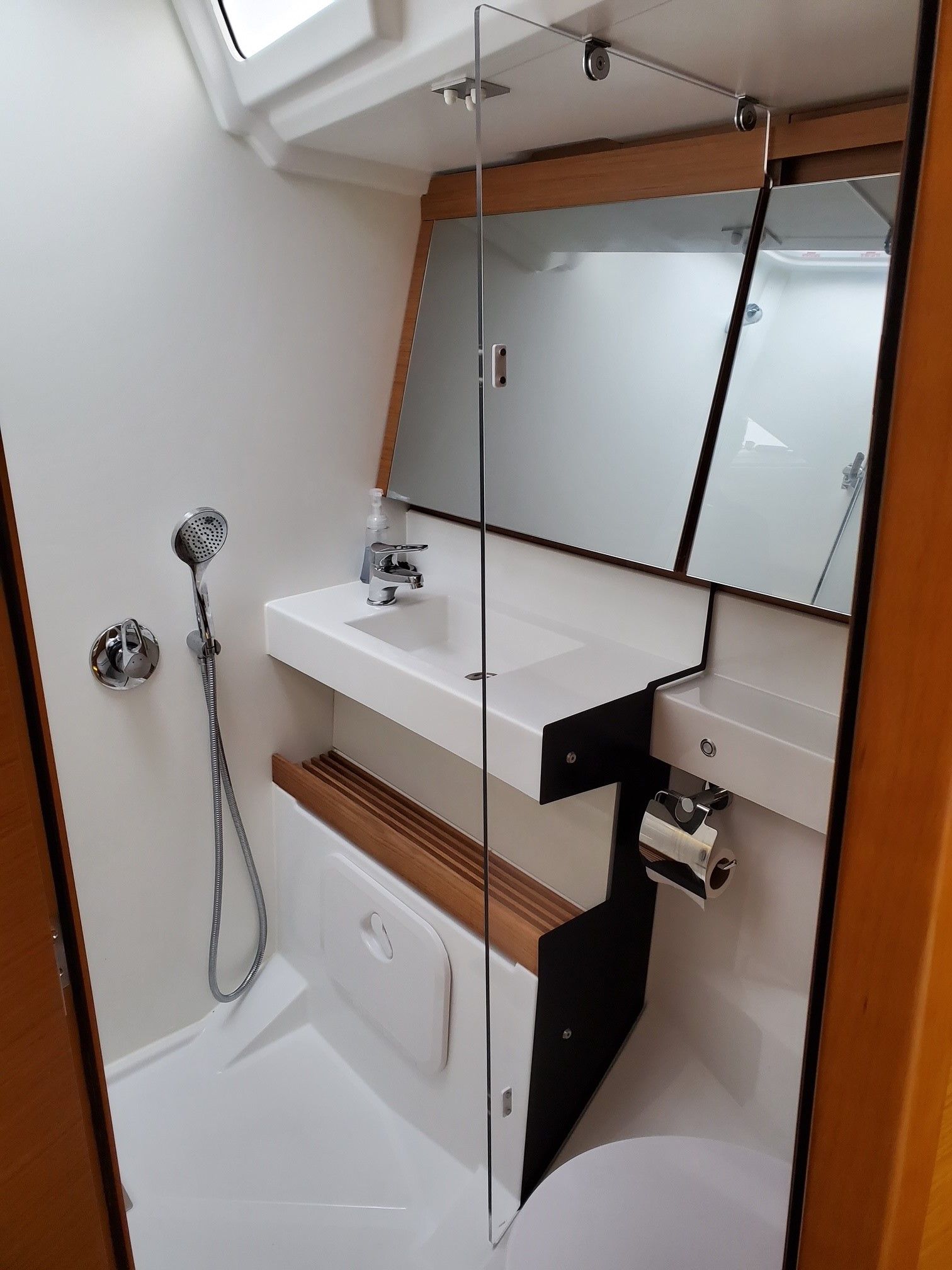 A bathroom with a sink a toilet and a mirror