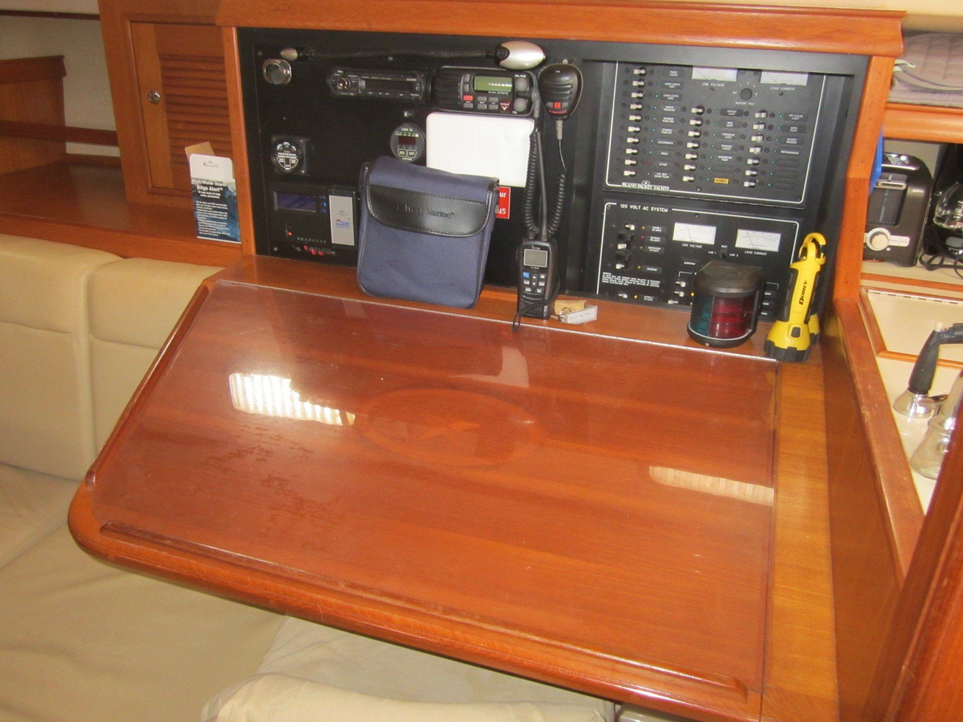 A wooden desk with a lot of electronics on it