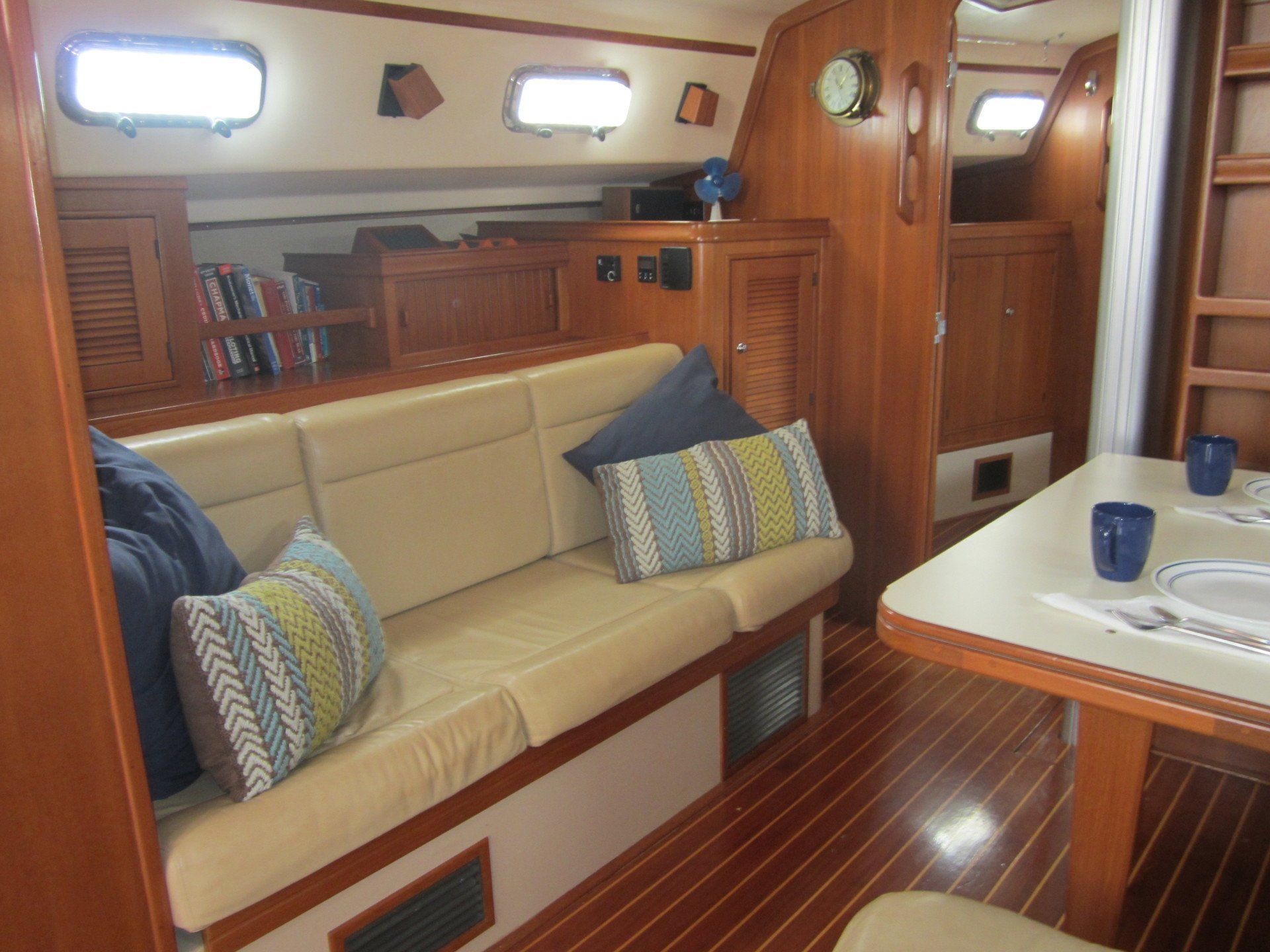 A living room on a boat with a couch and a table.