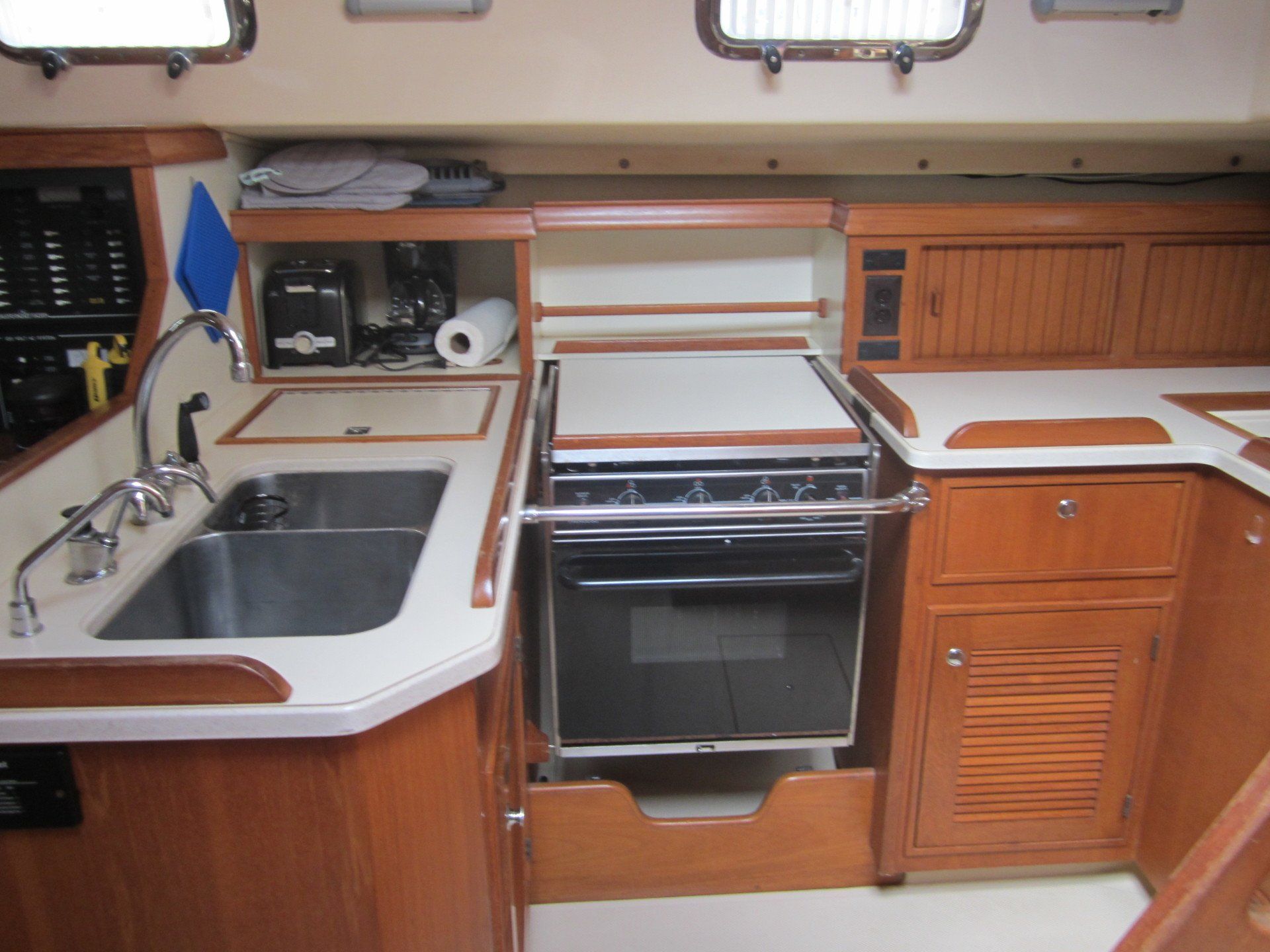 A kitchen on a boat with a sink and stove