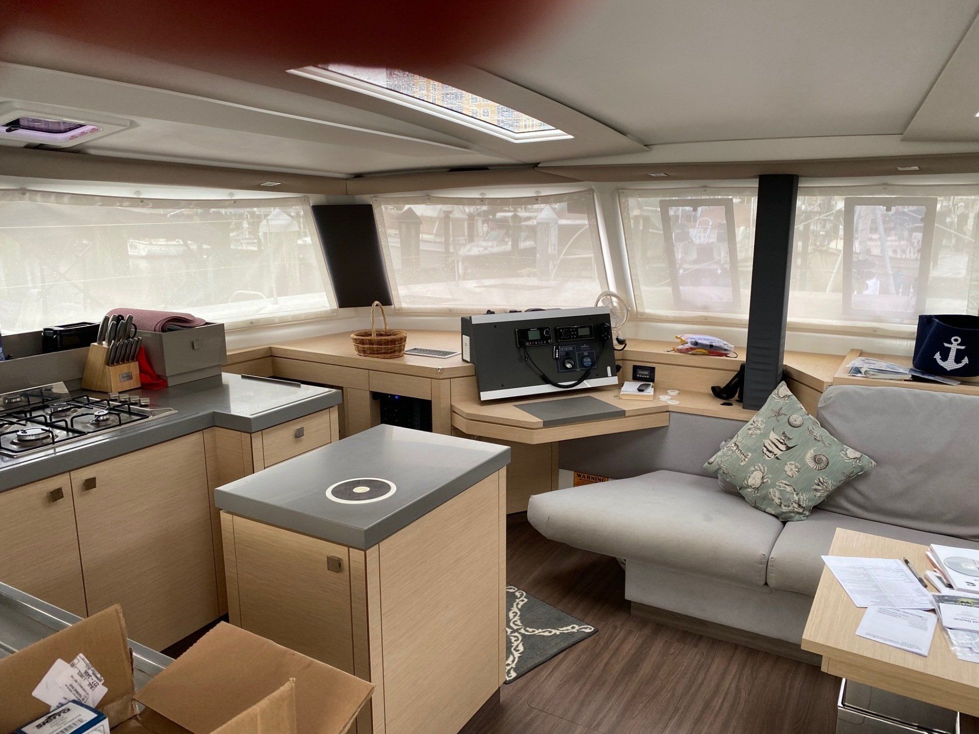 A living room on a boat with a couch , table , and computer.