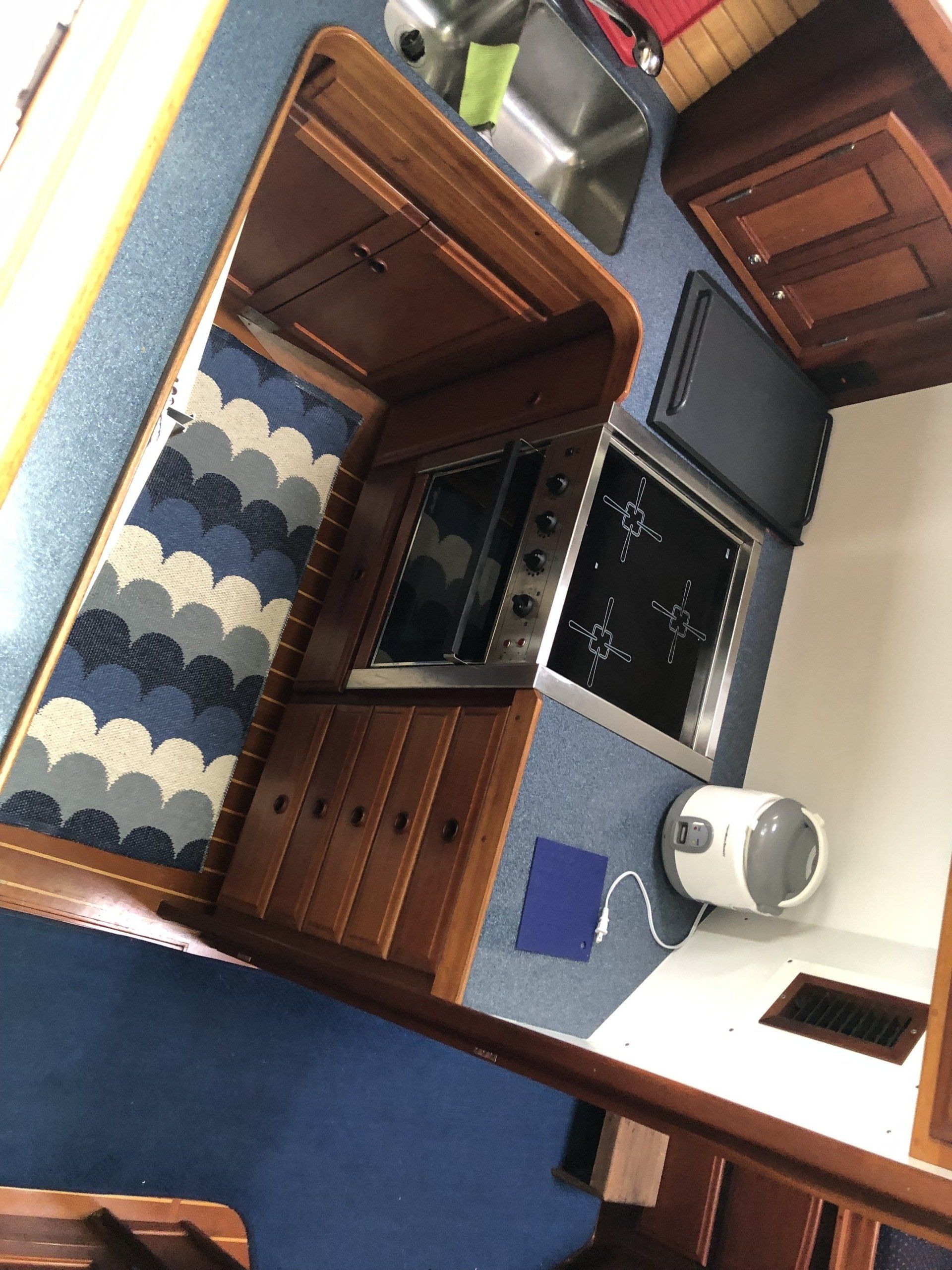 A kitchen with wooden cabinets and a stove top oven