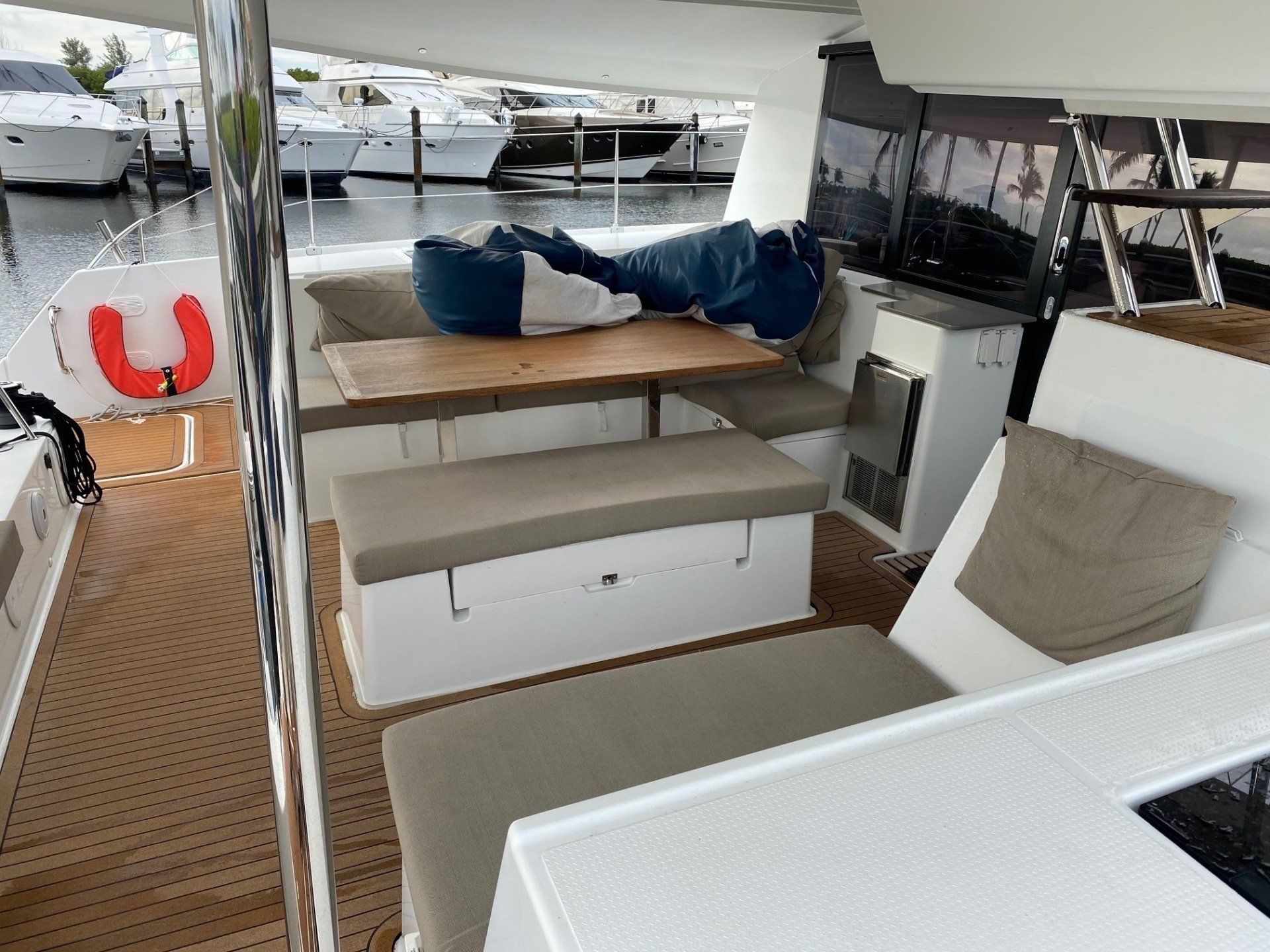 The inside of a boat with a table and chairs.