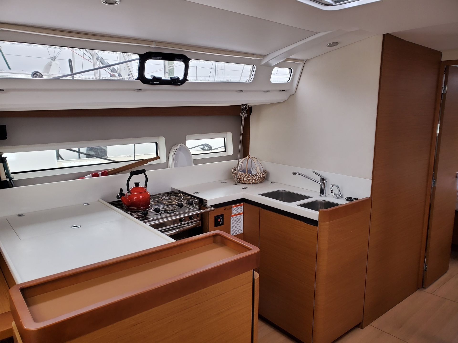 A kitchen on a boat with a stove and sink