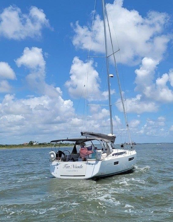 A sailboat is floating on top of a body of water.