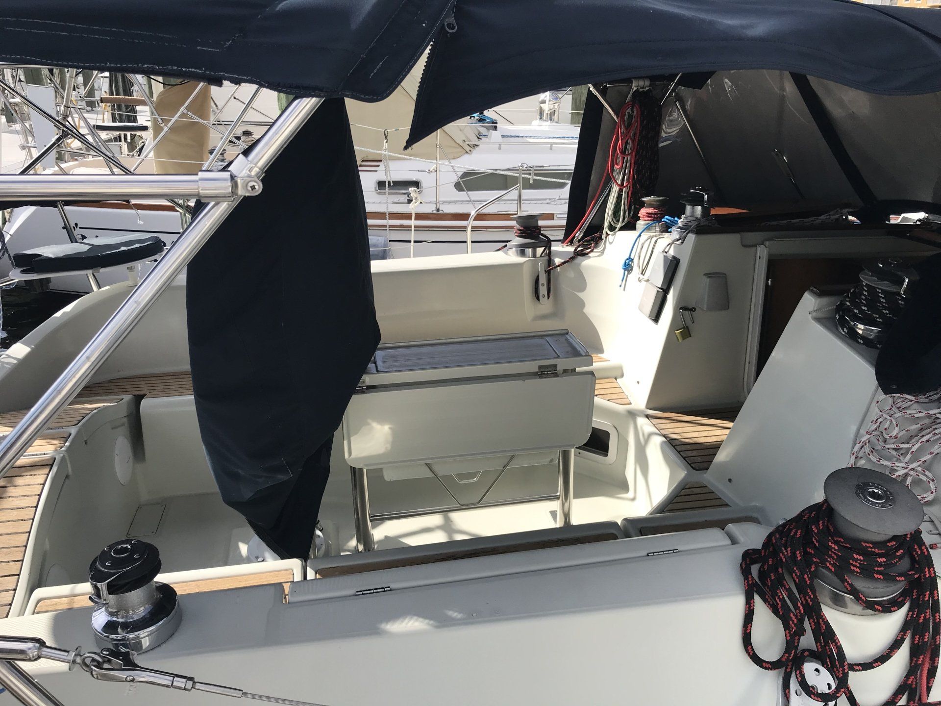 The inside of a boat with a black cover on the windshield.