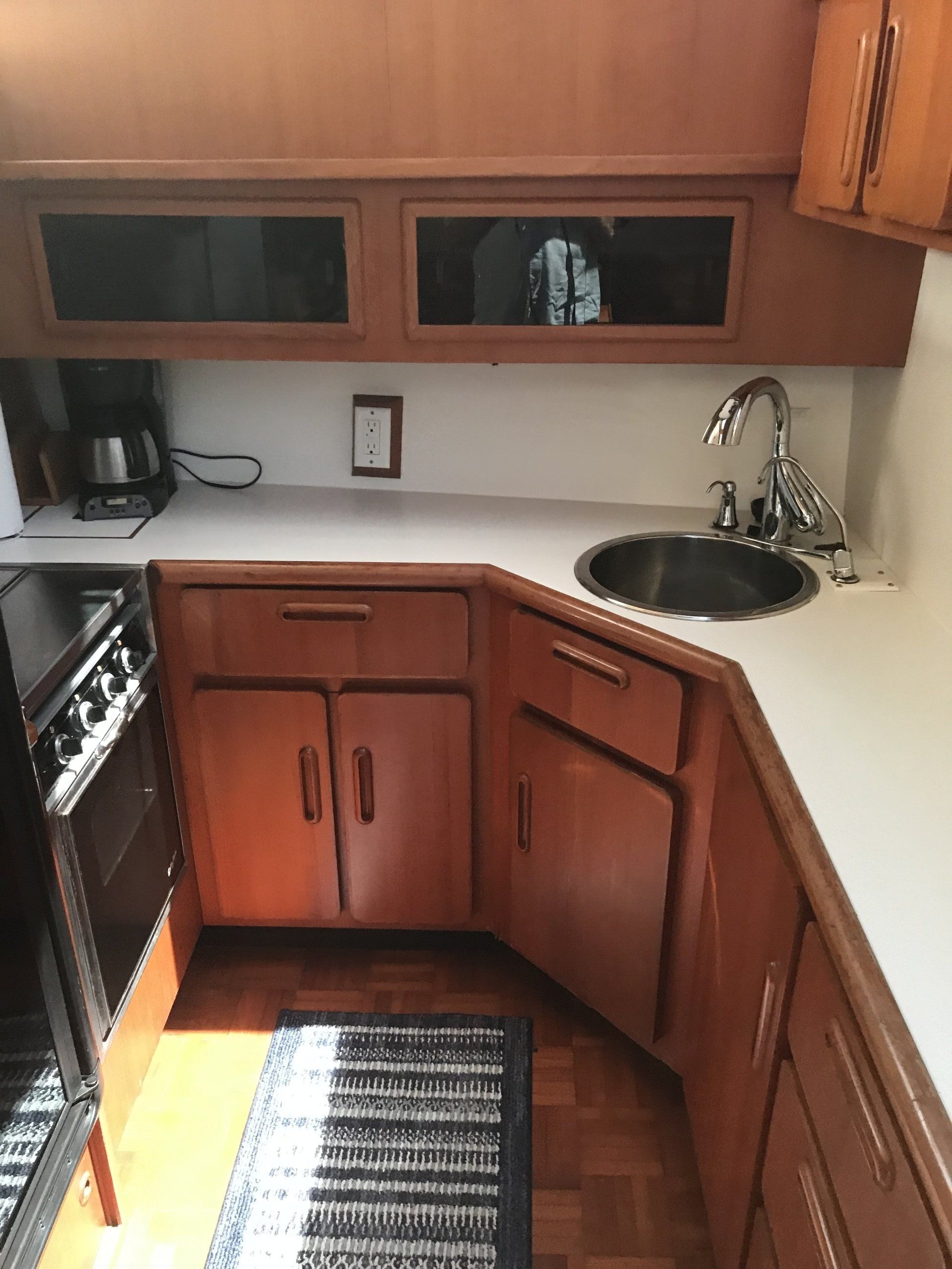A kitchen with wooden cabinets and a sink