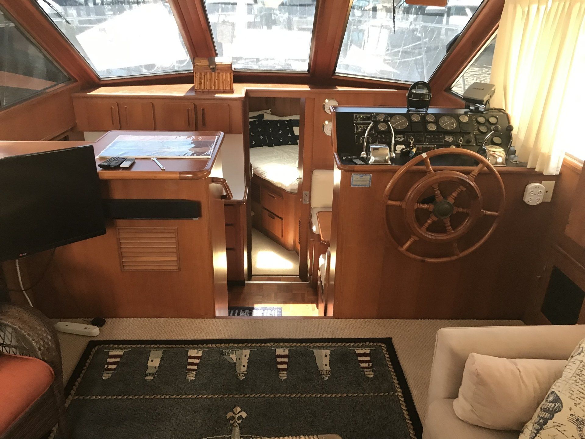The inside of a boat with a steering wheel