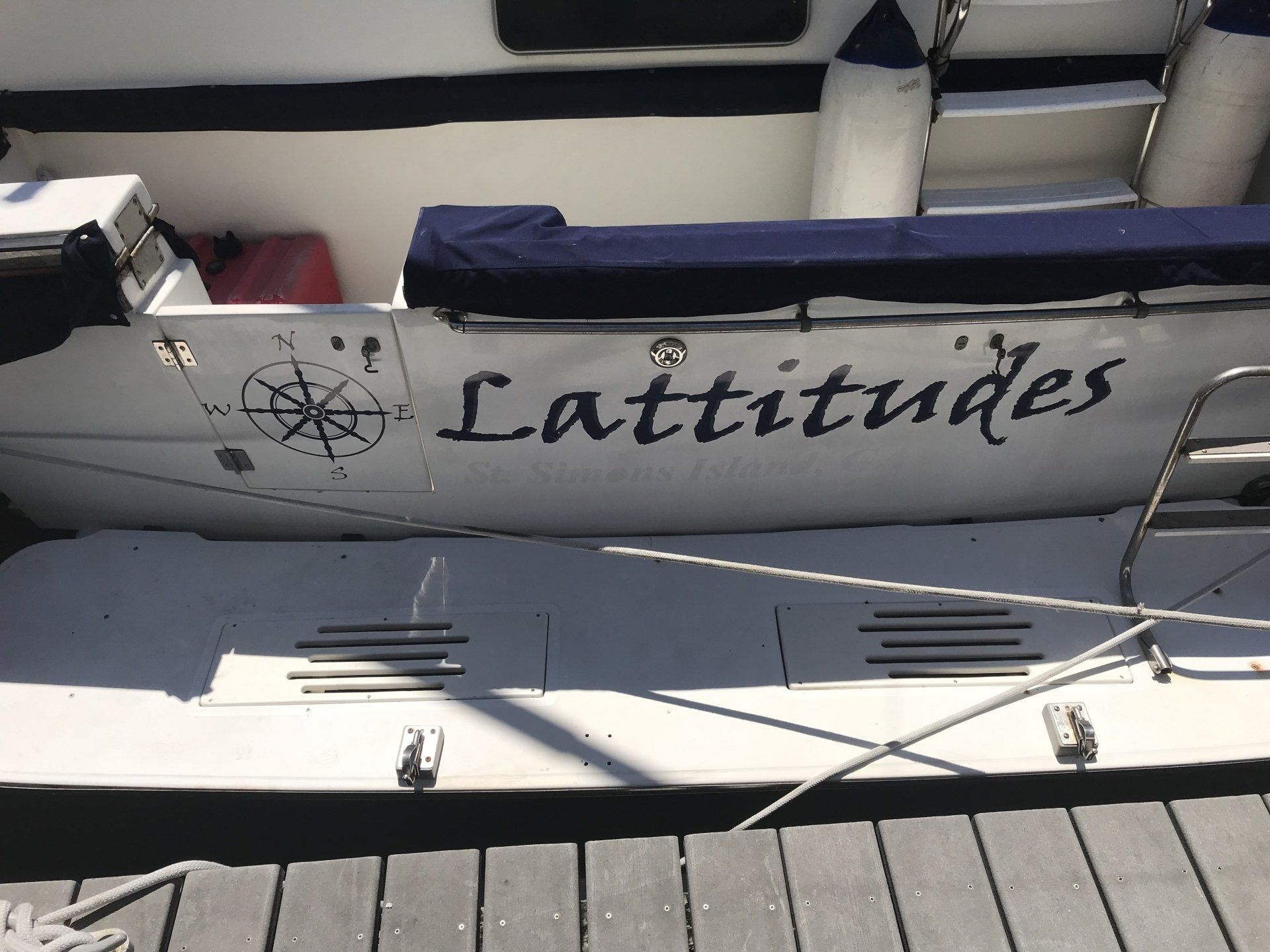 A boat with the name latitudes painted on the side