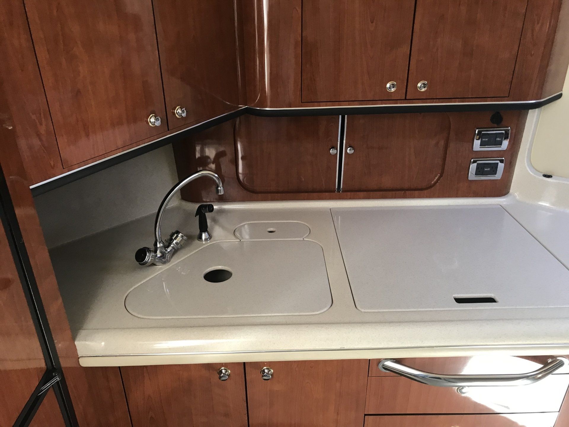 A kitchen with wooden cabinets and a sink