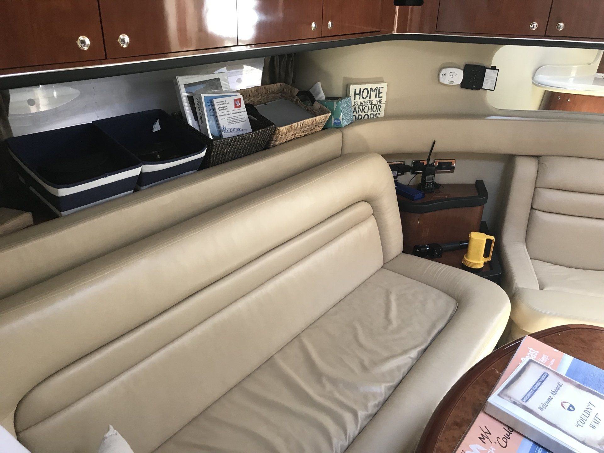 A couch is sitting in the middle of a room on a boat.