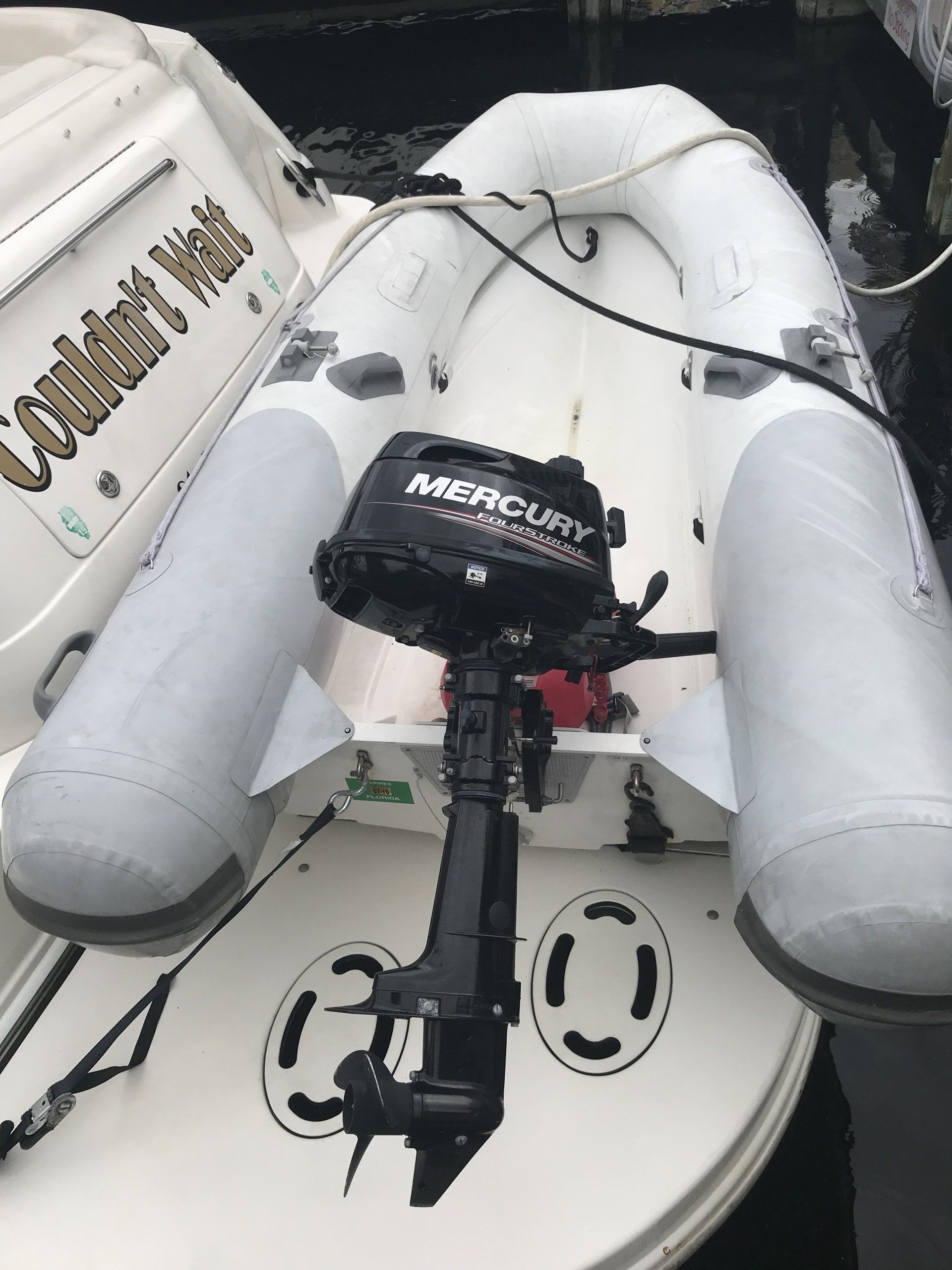 A mercury outboard motor is attached to the back of a boat