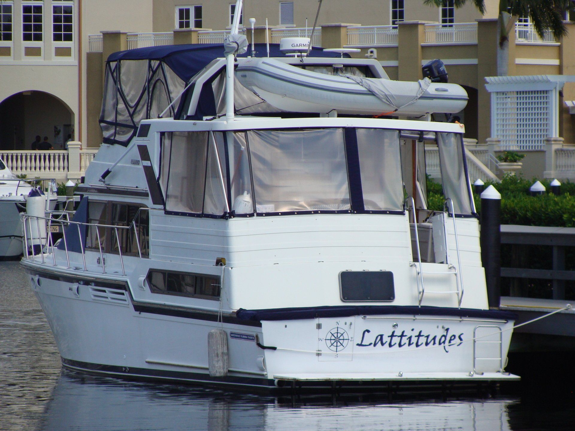 A white boat with the name latitudes on the back