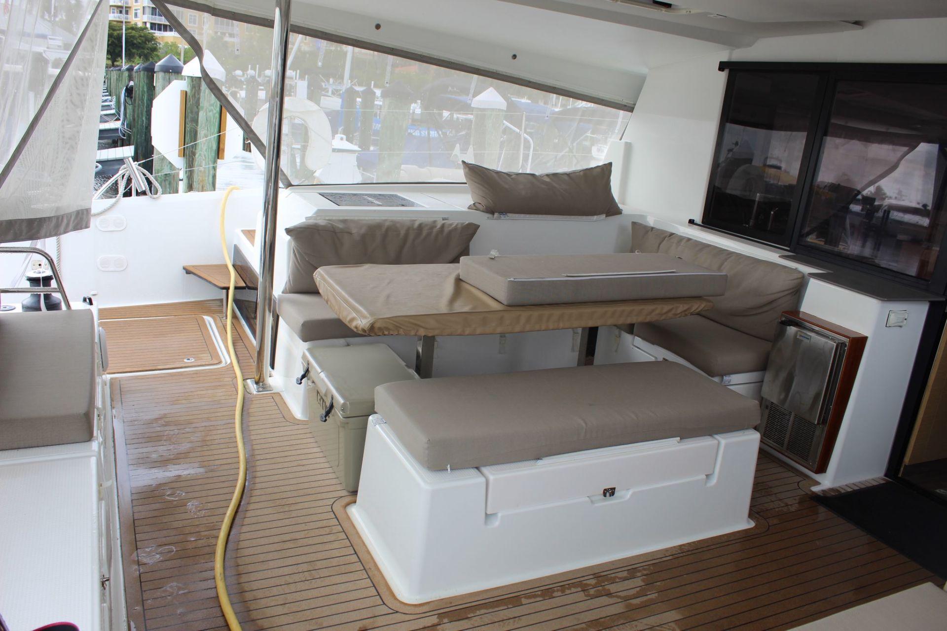 The inside of a boat with a table and benches.