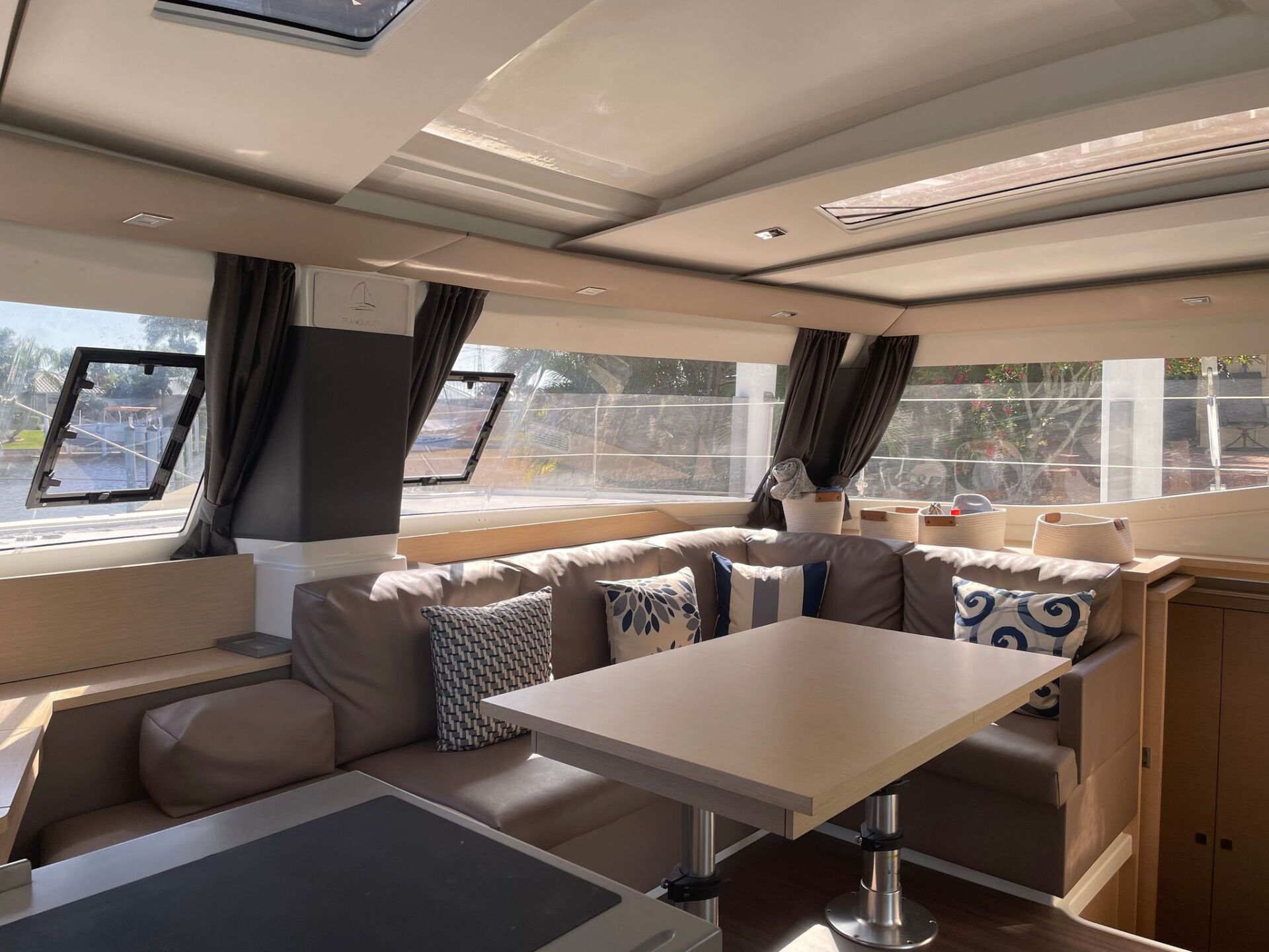 A living room on a boat with a table and couch.