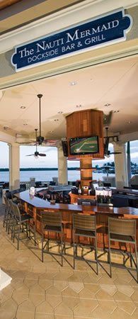 A restaurant with a long bar and a sign that says the north mermaid