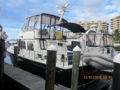 A boat is docked at a dock on a sunny day.