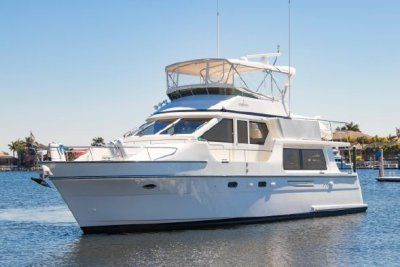 A white yacht is floating on top of a body of water.
