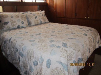 A bed with a quilt and pillows on it