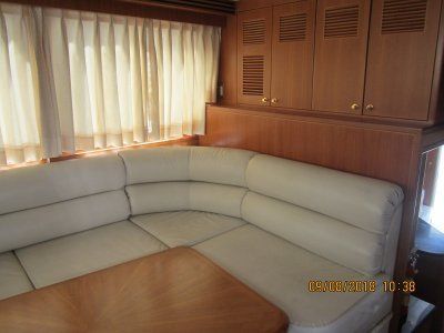 A living room on a boat with a couch and a table.