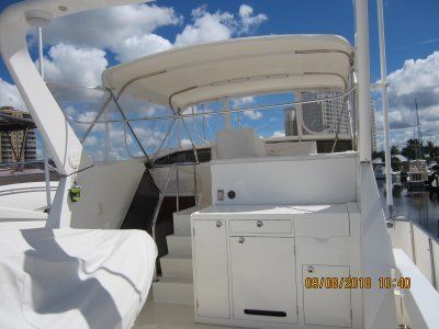 A white boat with a canopy on top of it