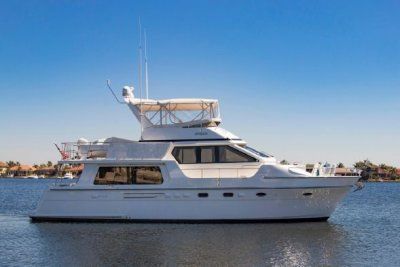 A large white yacht is floating on top of a body of water.
