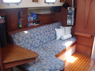 The inside of a boat with a couch and a table