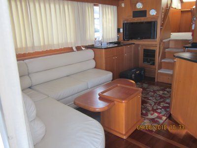 A living room on a boat with a couch and a table