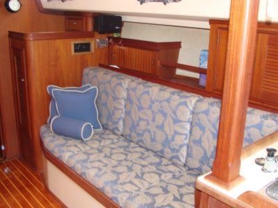 A couch with a blue pillow on it in a room