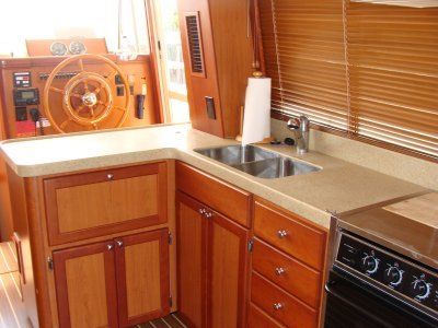 A kitchen with a sink stove and steering wheel