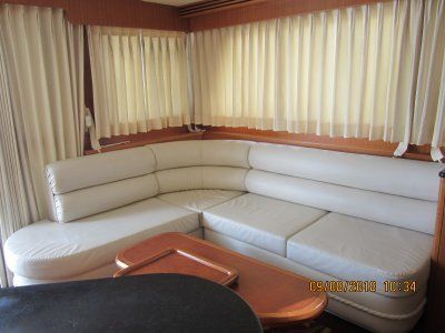 A living room on a boat with a couch and a table