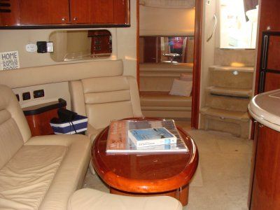 A living room on a boat with a sign that says home