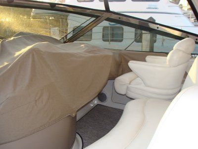 The inside of a boat with a cover on the seats