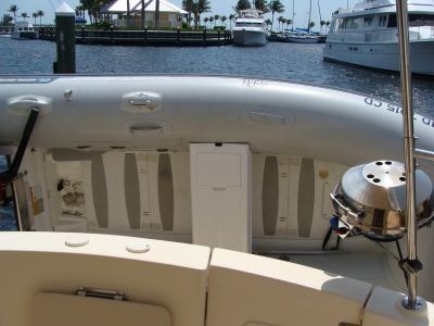 A boat is docked in a harbor with boats in the background