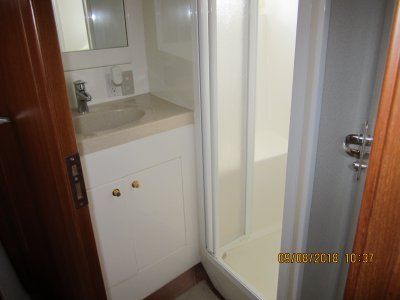 A bathroom with a sink and a shower.