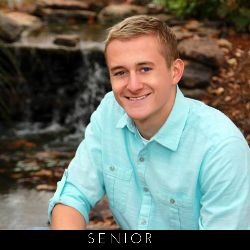 Smiling person in a light blue shirt sitting outdoors near a small waterfall, with “SENIOR” text below.