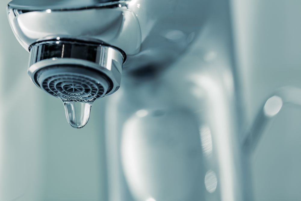A Close Up Of A Water Faucet With A Drop Of Water Coming Out Of It — Bay City Plumbing in Sunshine Acres, QLD