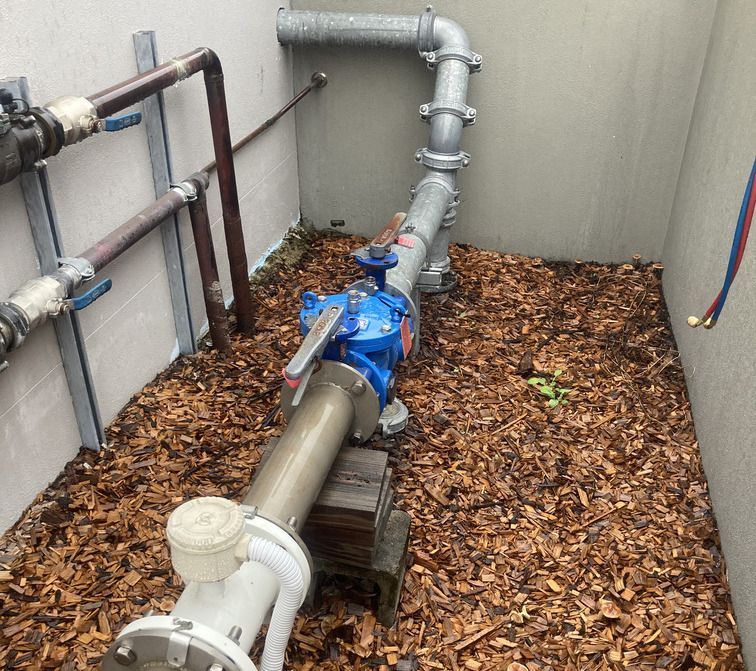 A Plumber Fixing A Sink In A Kitchen — Bay City Plumbing in Sunshine Acres, QLD