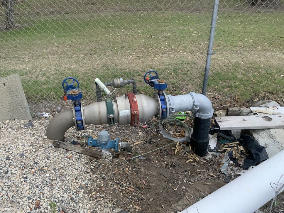 A Row Of Red Valves Sitting Next To Each Other In A Factory — Bay City Plumbing in Sunshine Acres, QLD