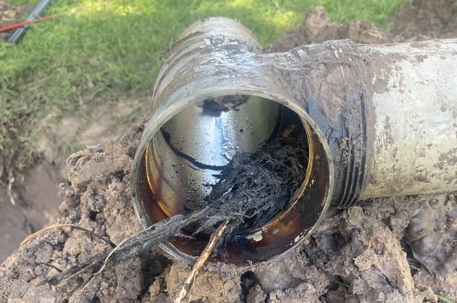 A Hole in the Ground With a Hose Coming Out of It — Bay City Plumbing in Hervey Bay, QLD